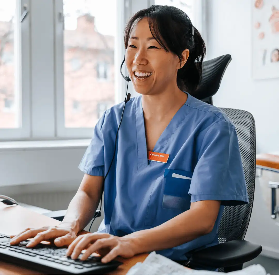 Smiling healthcare provider on her desktop
